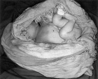 Infant body wrapped in a towel and blanket found hidden in a cupboard following a concealed home delivery